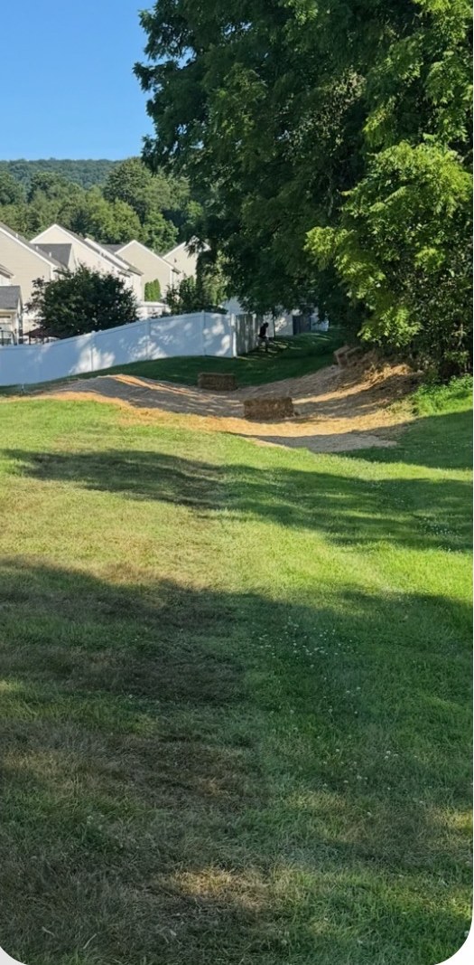 Regraded and seeded drainage swale behind a residential development in Breinigsville, PA