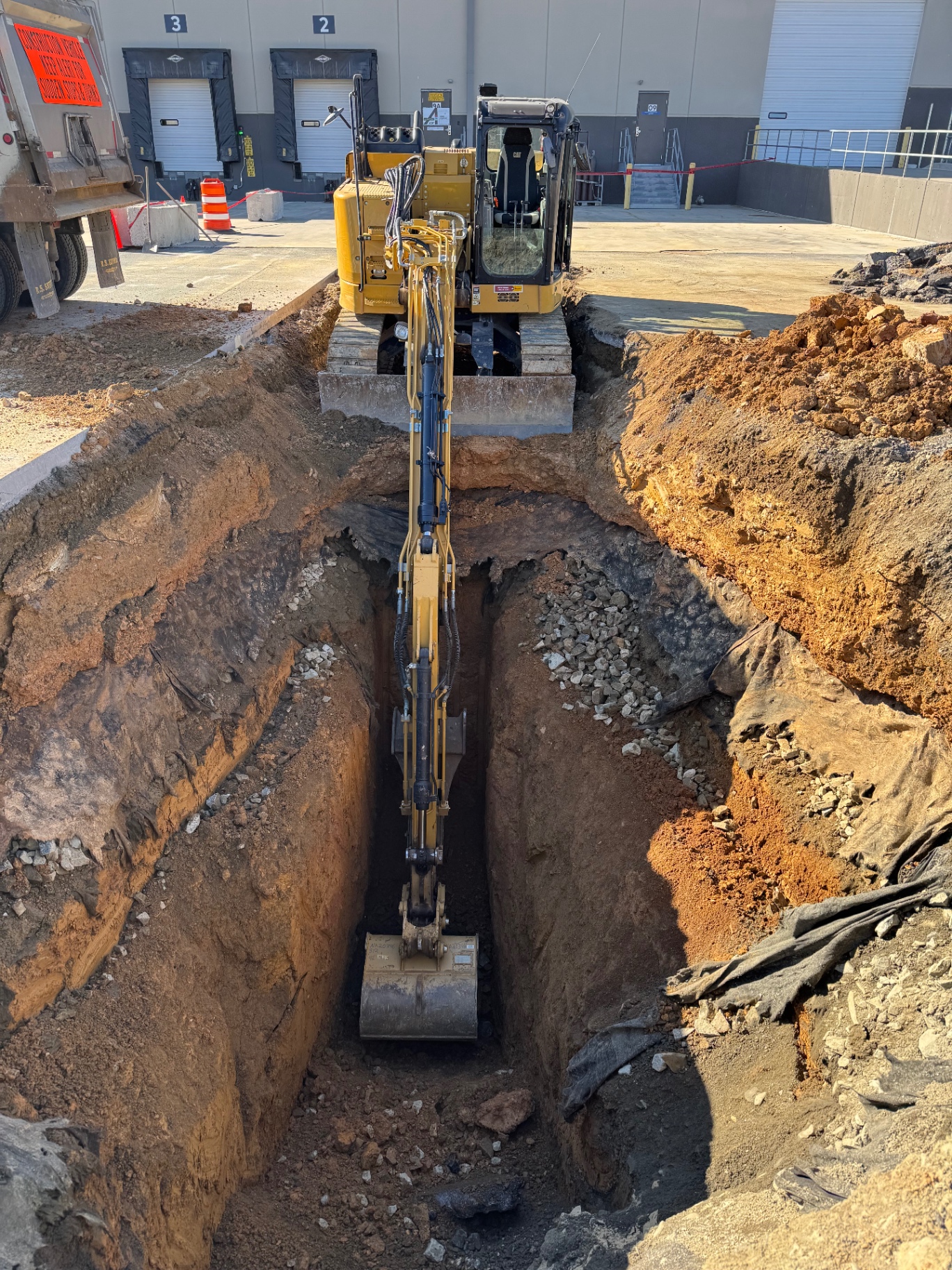 Wide view of a WoodEx jobsite with excavator working